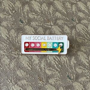 Free w/$25 purchase. One free item per cust. Colorful Social Battery Enamel Pin